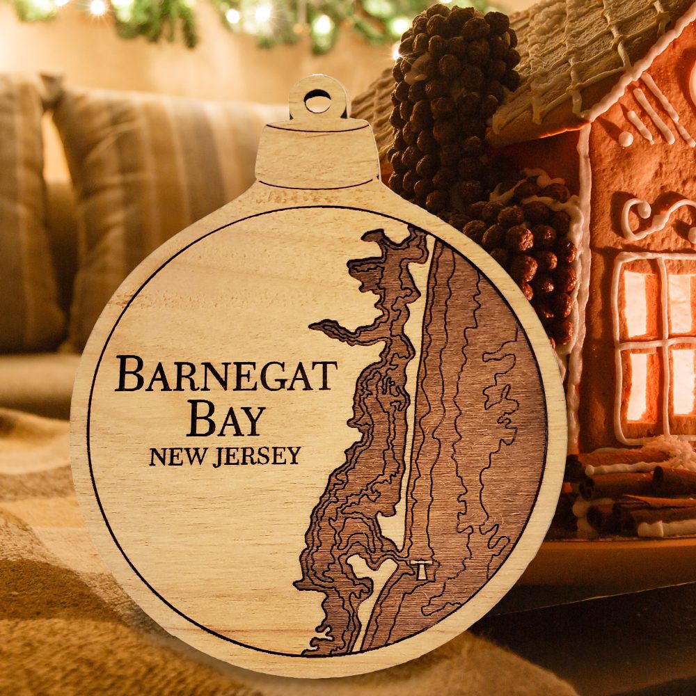 Barnegat Bay Engraved Nautical Ornament Sitting on Table with Gingerbread House