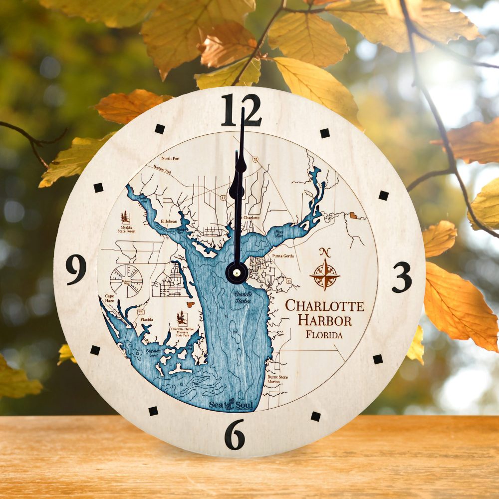Charlotte Harbor Nautical Clock Birch Accent with Blue Green Water on Table with Fall Leaves