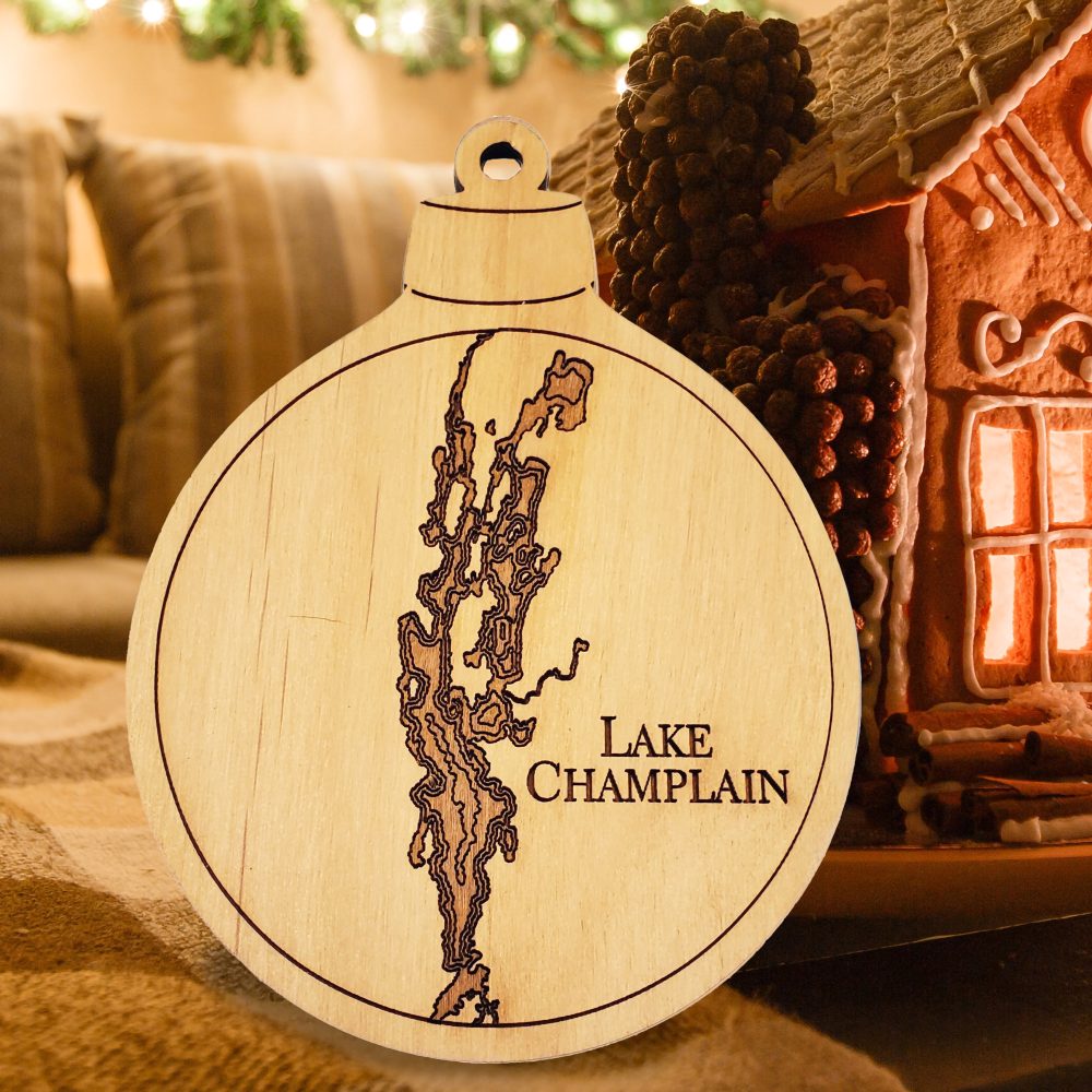 Lake Champlain Engraved Nautical Ornament Sitting on Table with Gingerbread House