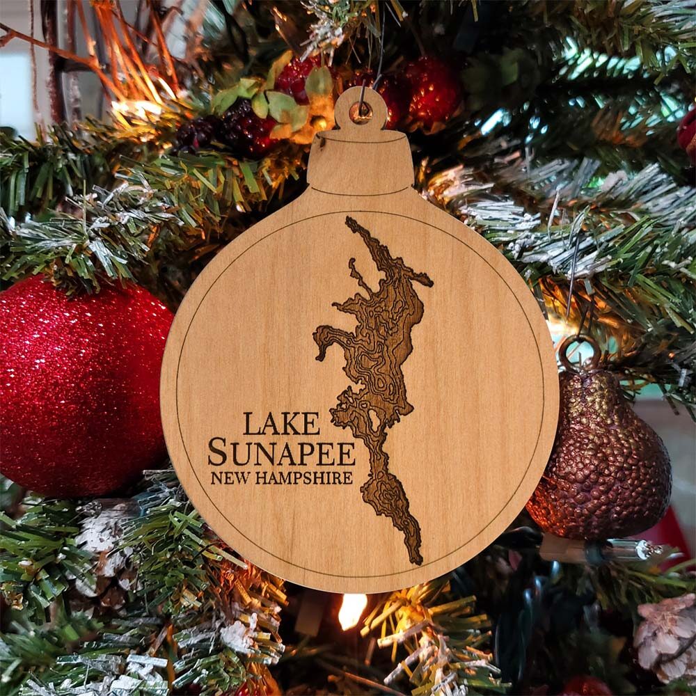 Lake Sunapee Engraved Nautical Ornament Hanging on Christmas Tree with Red Ornaments