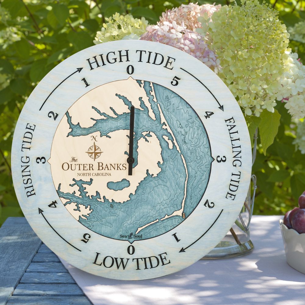 Outer Banks Tide Clock Bleach Blue Accent with Blue Green Water Sitting on Table with Flowers