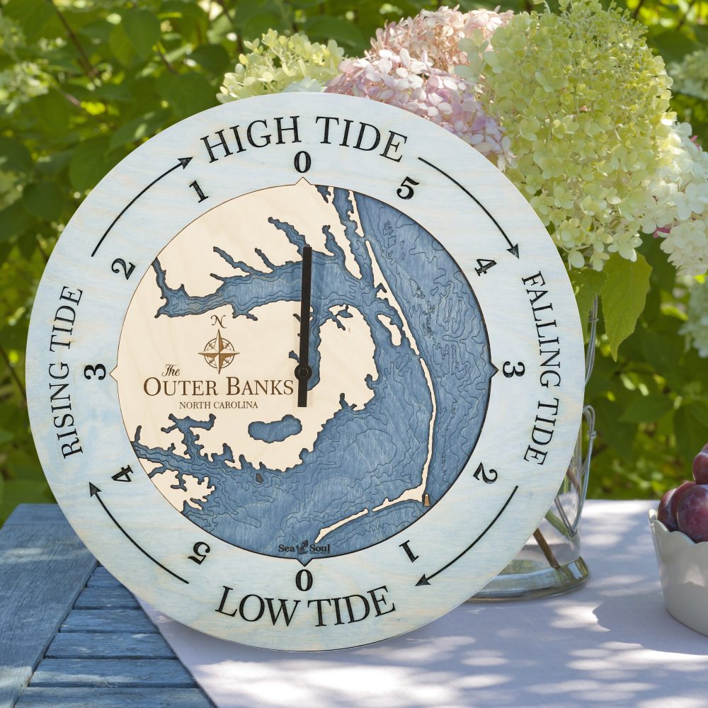Outer Banks Tide Clock Bleach Blue Accent with Deep Blue Water Sitting on Table with Flowers