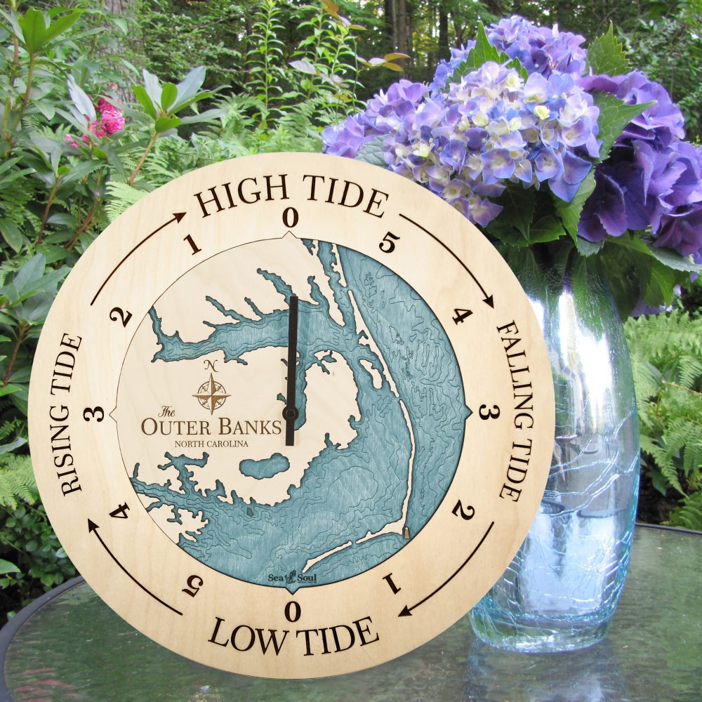 Outer Banks Tide Clock Birch Accent with Blue Green Water Sitting on Table with Flowers