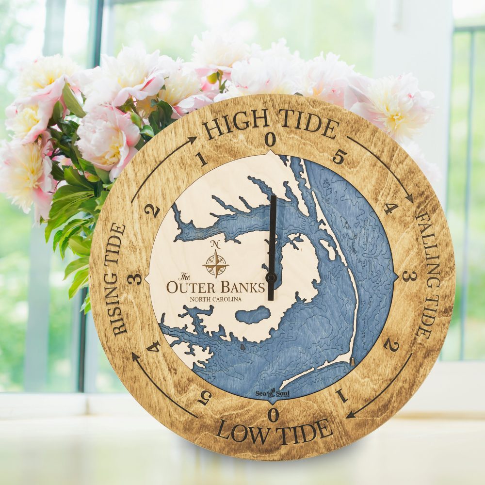 Outer Banks Tide Clock Honey Accent with Deep Blue Water Sitting on Windowsill with Flowers