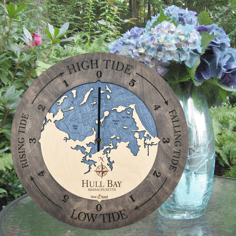 Hull Bay Tide Clock Driftwood Accent with Deep Blue Water Sitting on Outdoor Table with Flowers