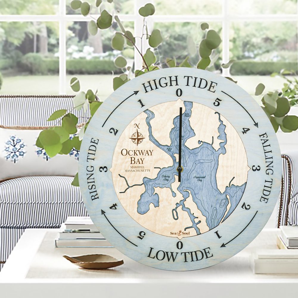 Ockway Bay Tide Clock Bleach Blue Accent with Deep Blue Water on Coffee Table with Potted Plant