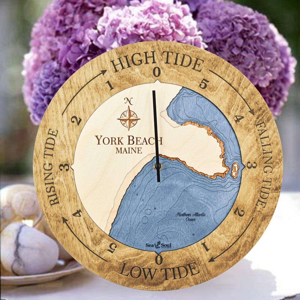York Beach Tide Clock Honey Accent with Deep Blue Water Sitting on Table with Flowers