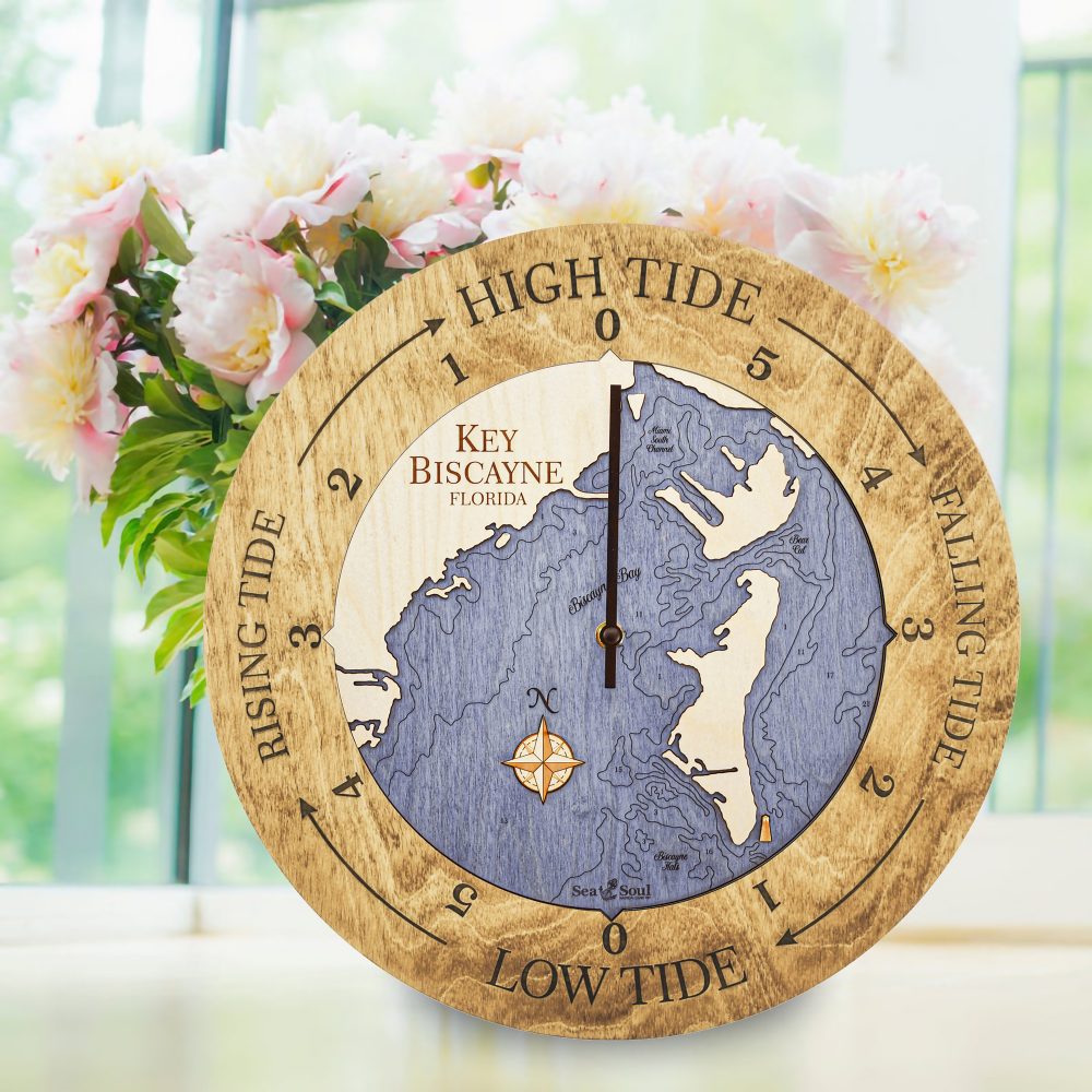 Key Biscayne Tide Clock Honey Accent with Deep Blue Water Sitting on Windowsill with Flowers