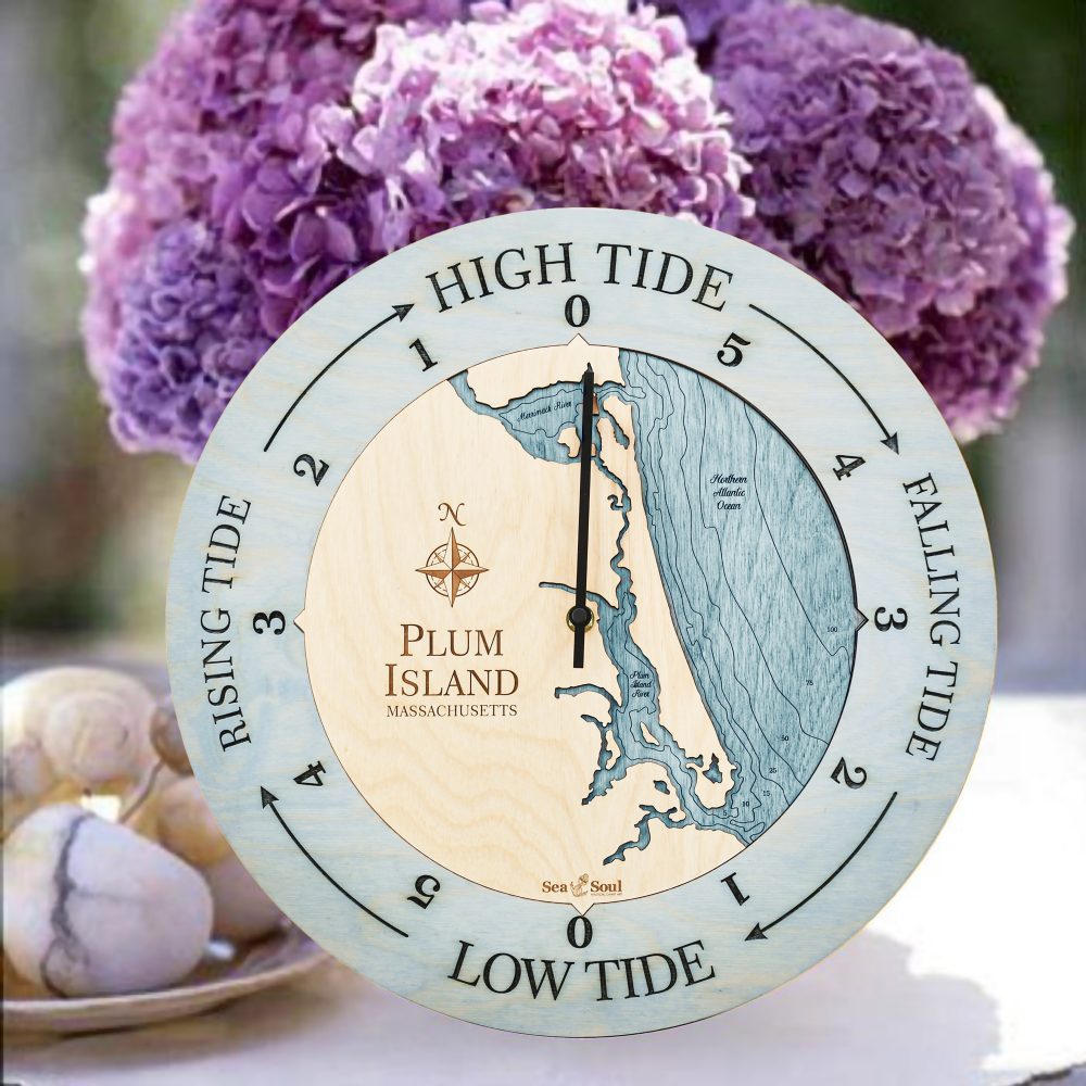 Plum Island Tide Clock Bleach Blue Accent with Blue Green Water Sitting on Table with Flowers