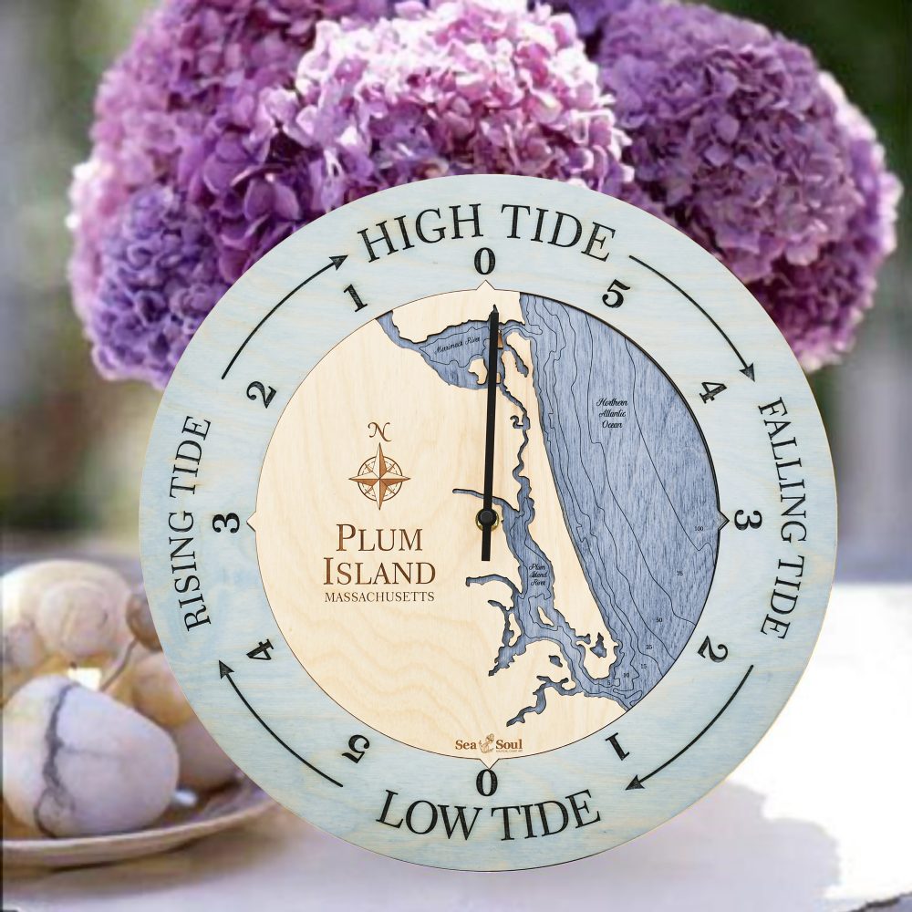 Plum Island Tide Clock Bleach Blue Accent with Deep Blue Water Sitting on Table with Flowers