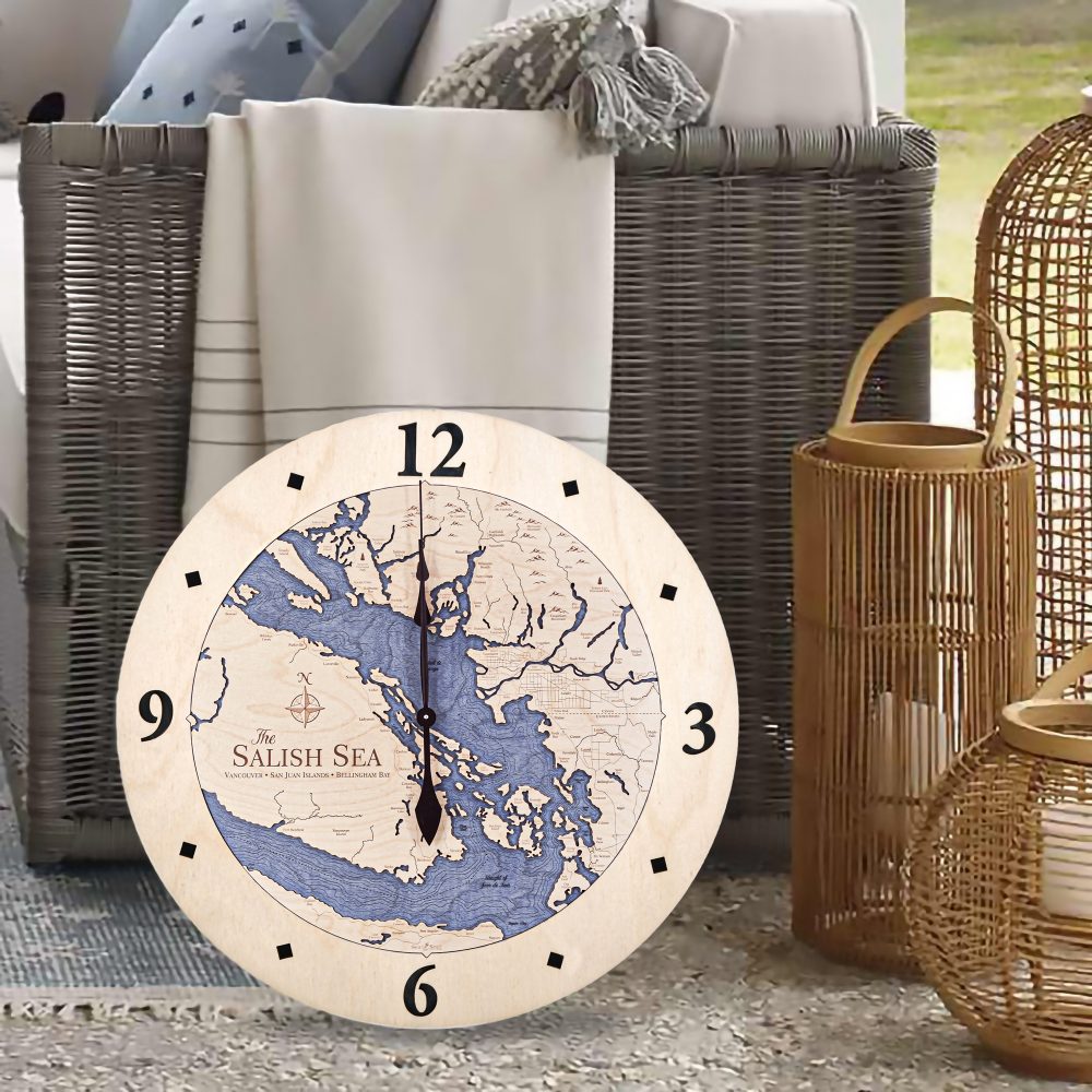 Salish Sea Nautical Clock Birch Accent with Deep Blue Water Sitting on Floor by Wicker Chair