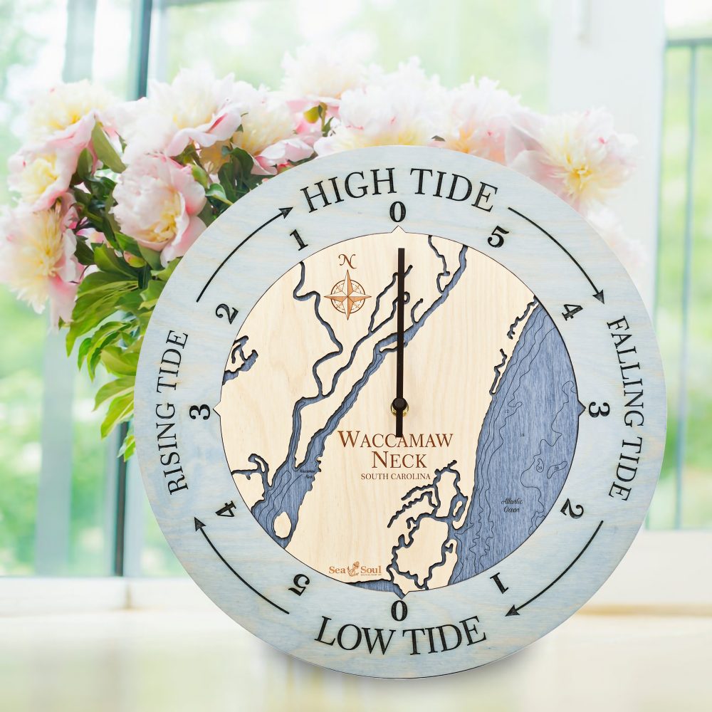 Waccamaw Neck Tide Clock Bleach Blue Accent with Deep Blue Water Sitting on Windowsill with Flowers