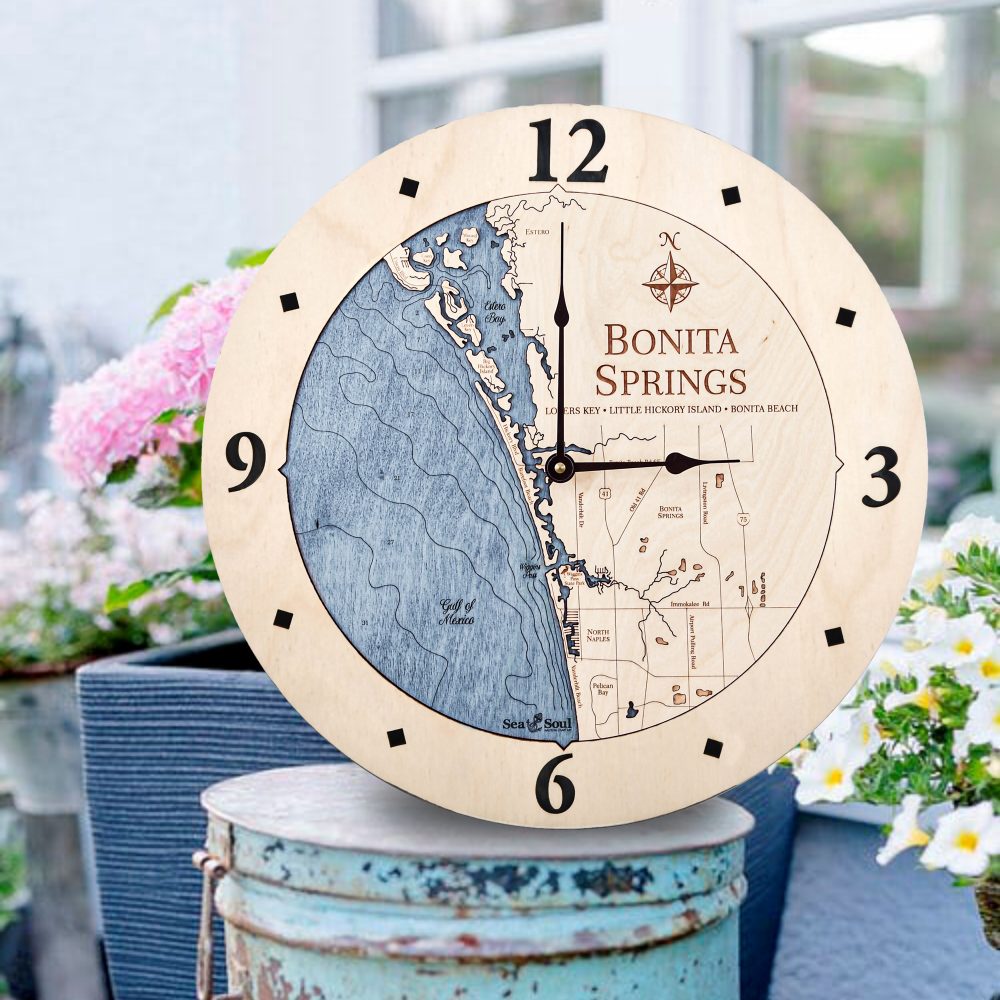 Bonita Springs Nautical Clock Birch Accent with Deep Blue Water Sitting on Bucket Outdoors by Flowers