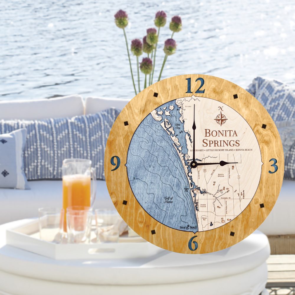 Bonita Springs Nautical Clock Honey Accent with Deep Blue Water Sitting on Outdoor Table by Waterfront