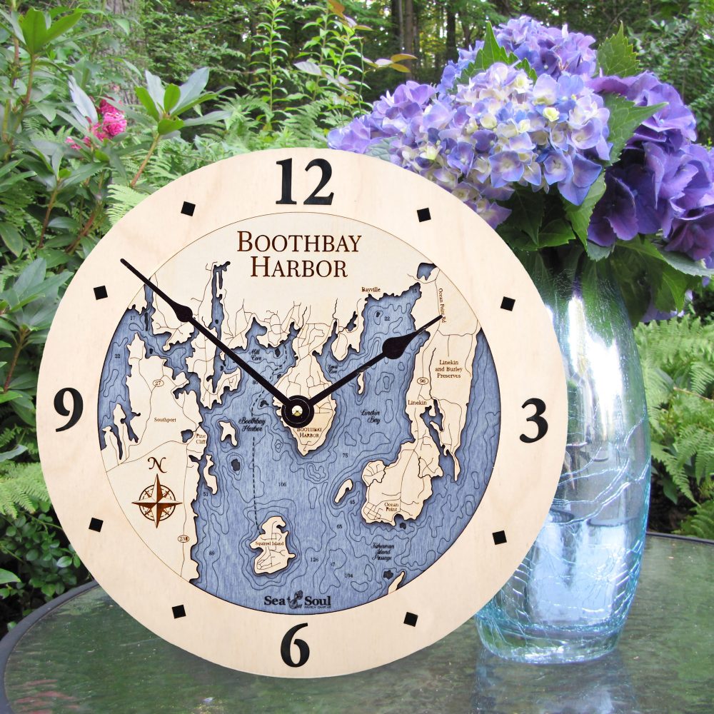 Boothbay Harbor Nautical Clock Birch Accent with Deep Blue Water Sitting on Outdoor Table with Flowers