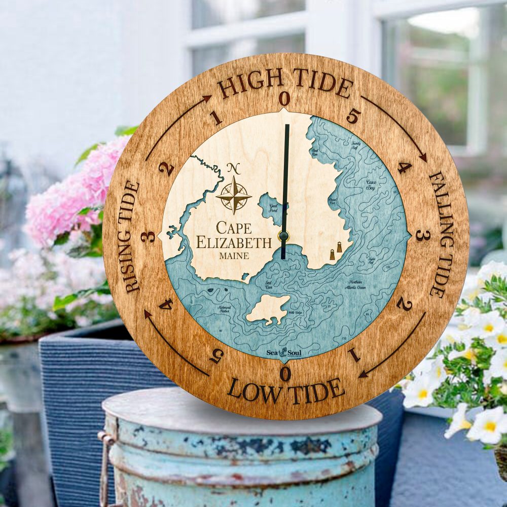 Cape Elizabeth Tide Clock Americana Accent with Blue Green Water Sitting on Bucket Outdoors by Flowers