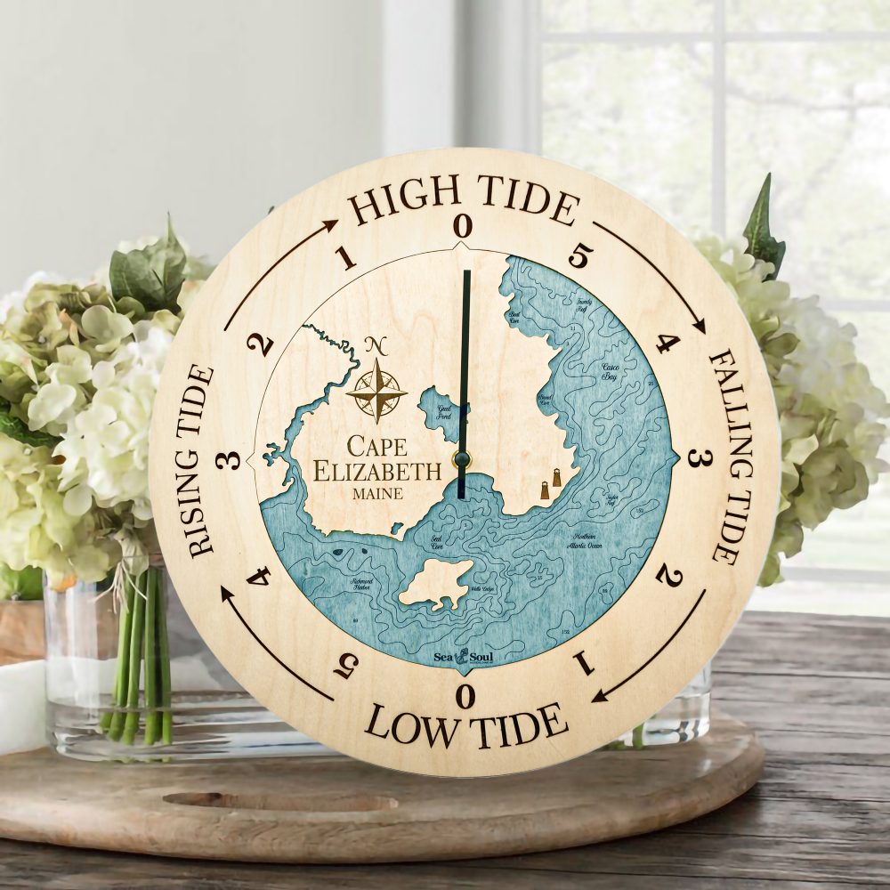 Cape Elizabeth Tide Clock Birch Accent with Blue Green Water Sitting on Table with Flowers