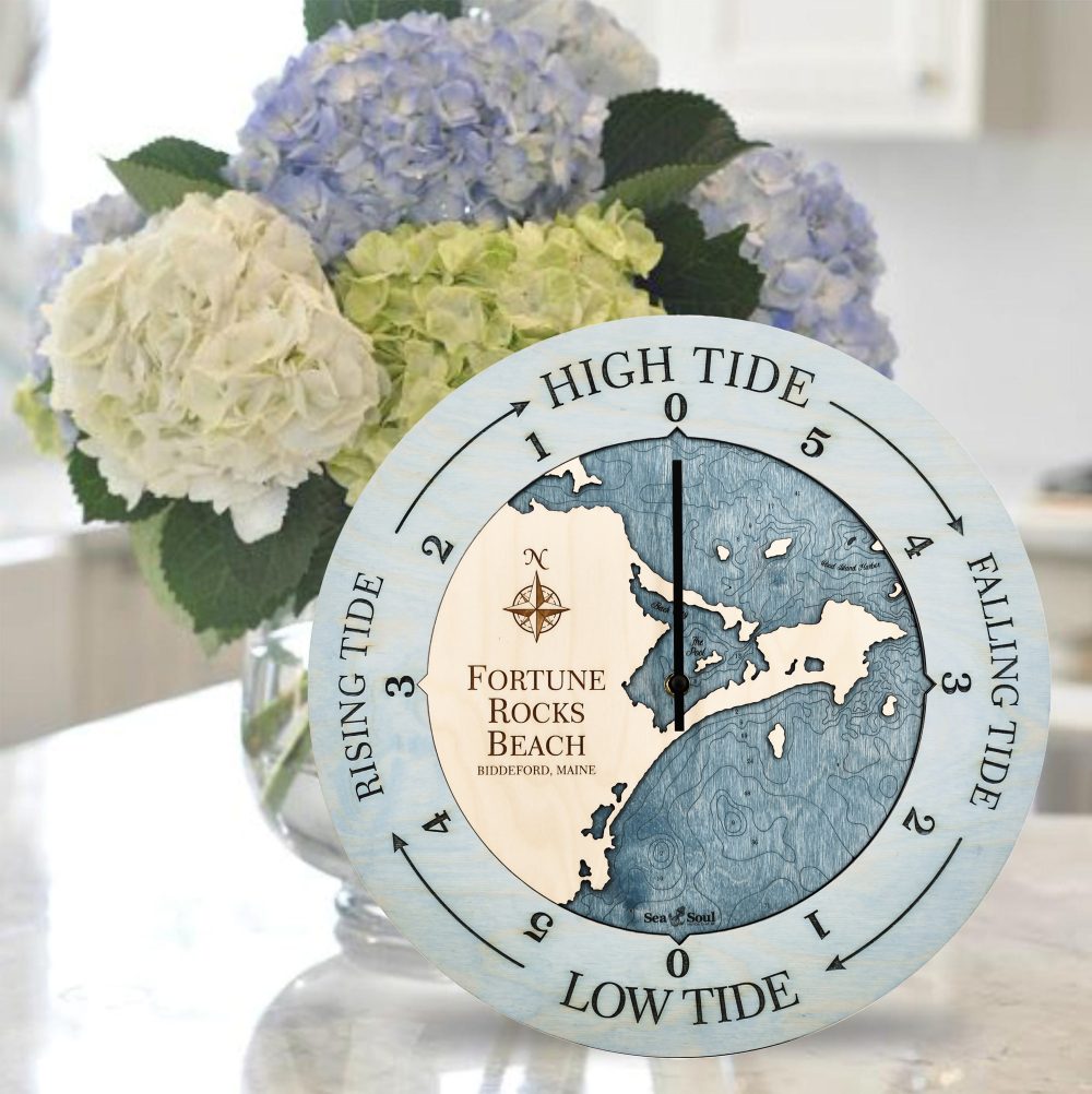 Fortune Rocks Beach Tide Clock Bleach Blue Accent with Deep Blue Water Sitting on Countertop with Flowers