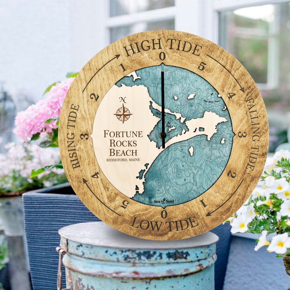 Fortune Rock Beach Tide Clock Honey Accent with Blue Green Water Sitting on Outdoor Bucket by Flowers