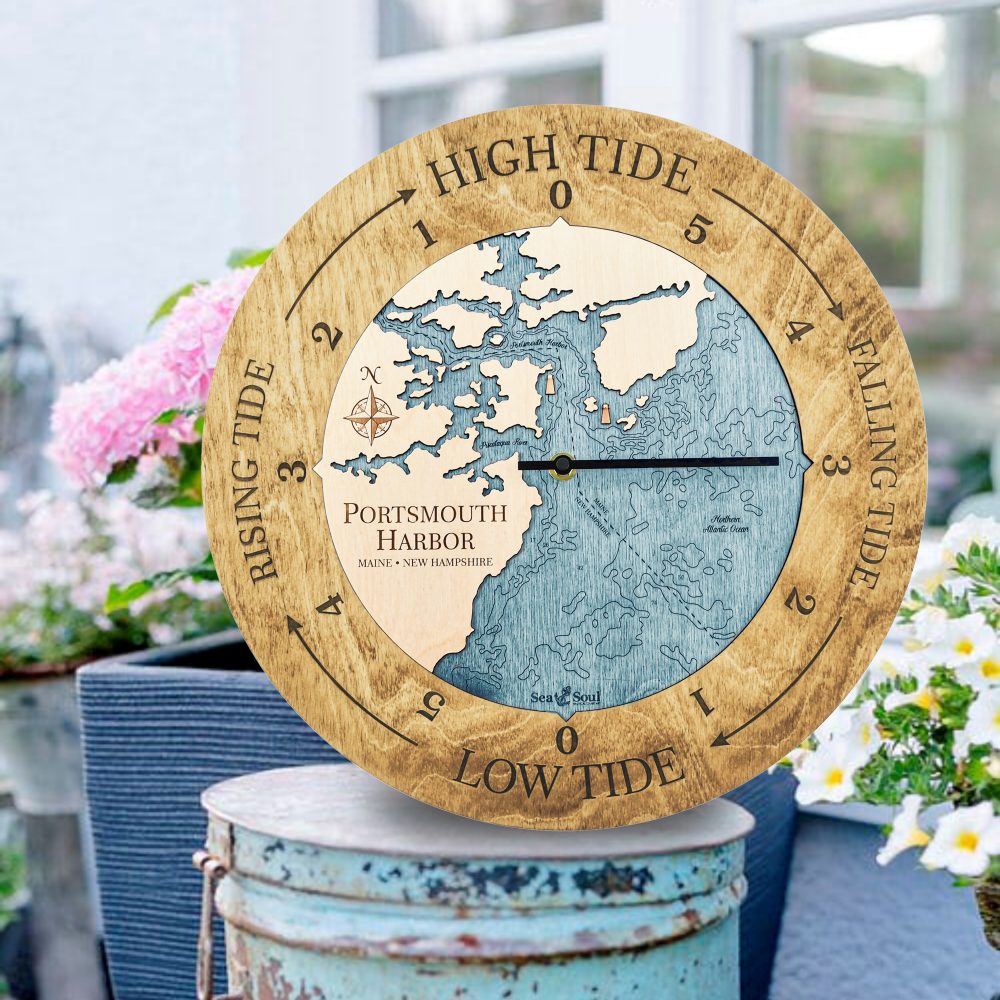 Portsmouth Harbor Tide Clock Honey Accent with Blue Green Water Sitting on Outdoor Bucket by Flowers
