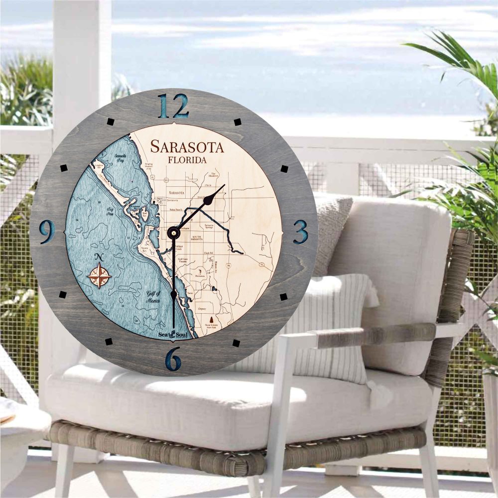 Sarasota Nautical Clock Driftwood Accent with Blue Green Water Sitting on Outdoor Chair