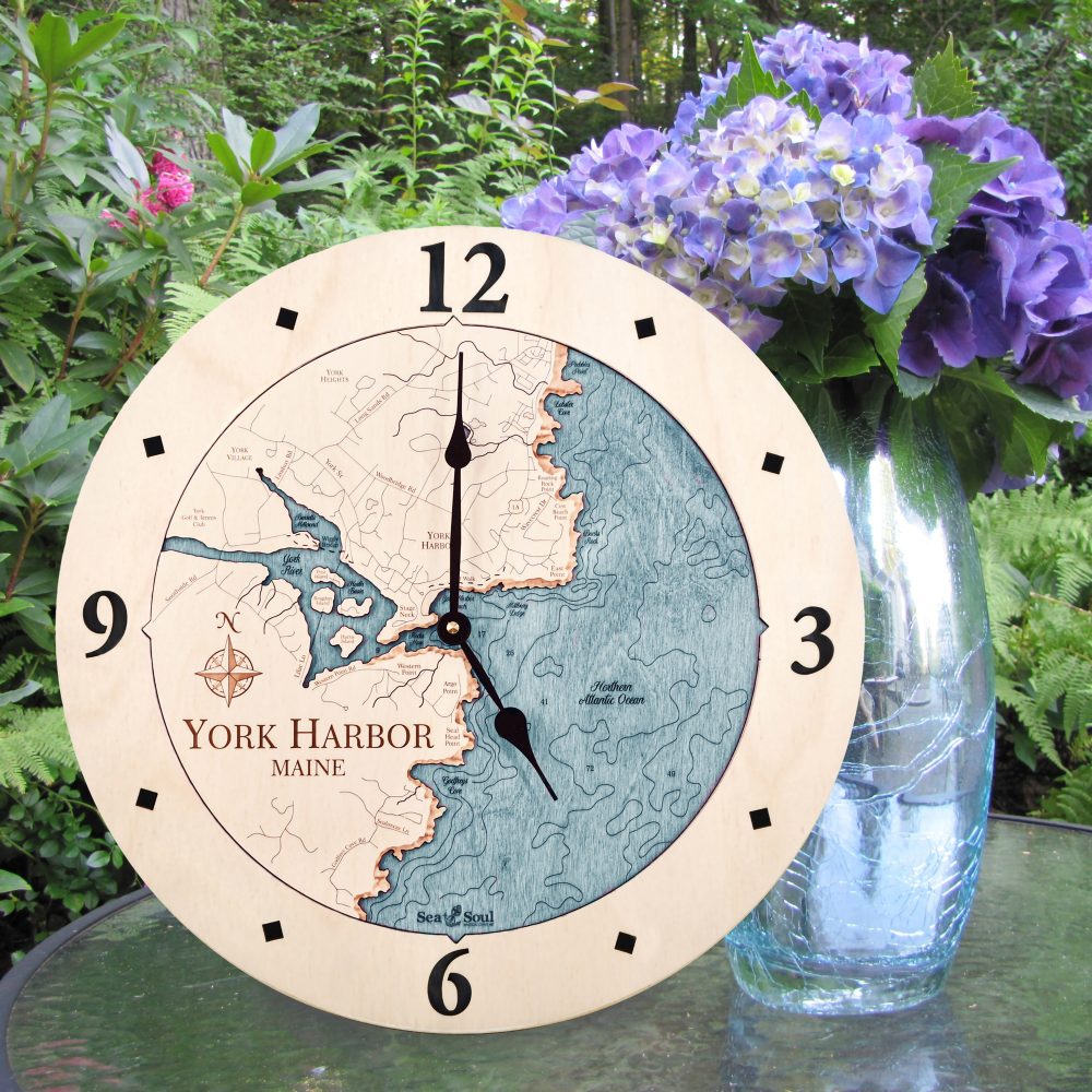 York Harbor Nautical Clock Birch Accent with Blue Green Water Sitting on Outdoor Table with Flowers