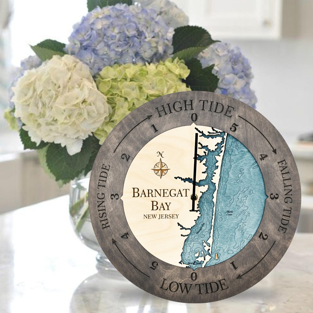 Barnegat Bay Tide Clock Driftwood Accent with Blue Green Water Sitting on Countertop with Flowers