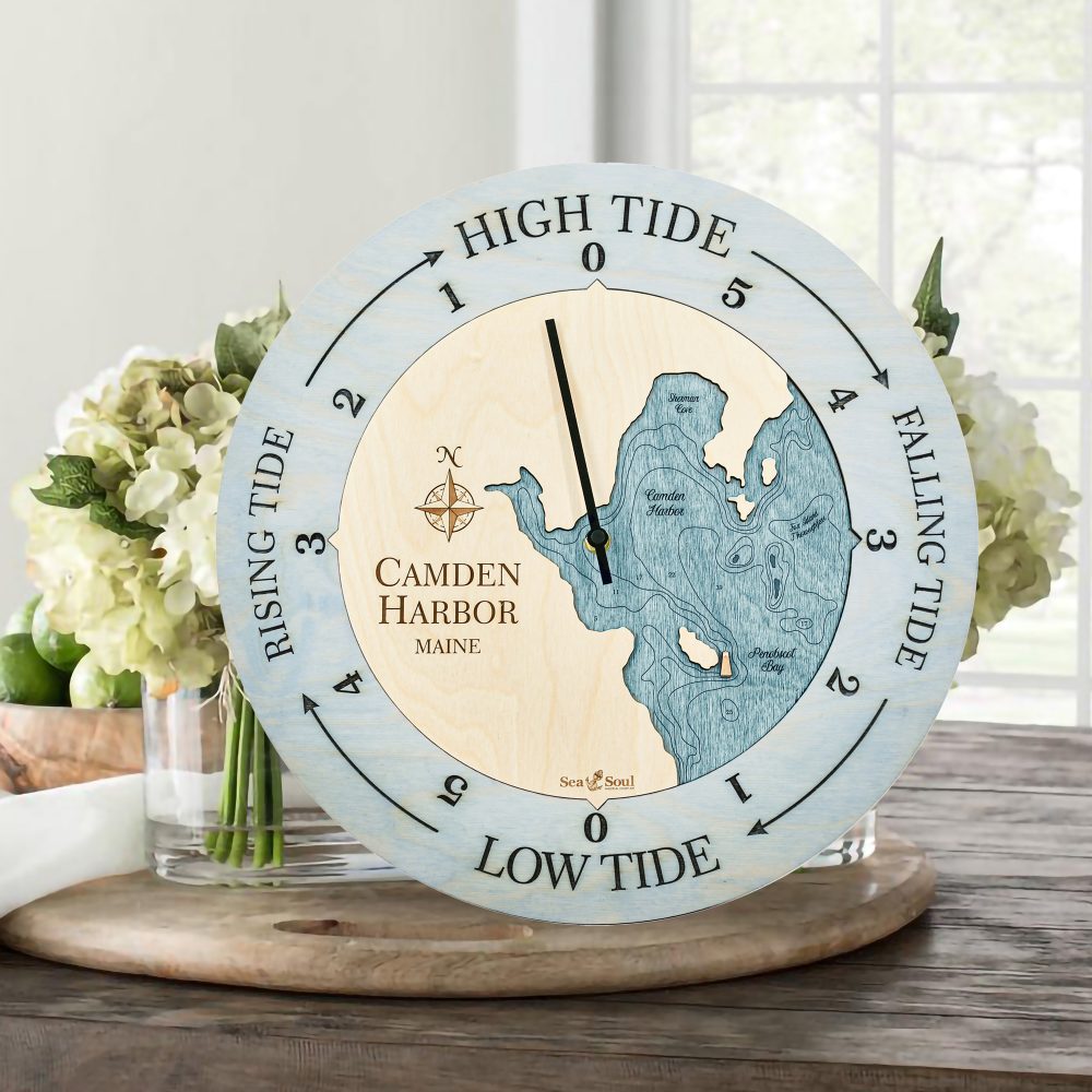 Camden Harbor Tide Clock Bleach Blue Accent with Blue Green Water Sitting on Table with Flowers