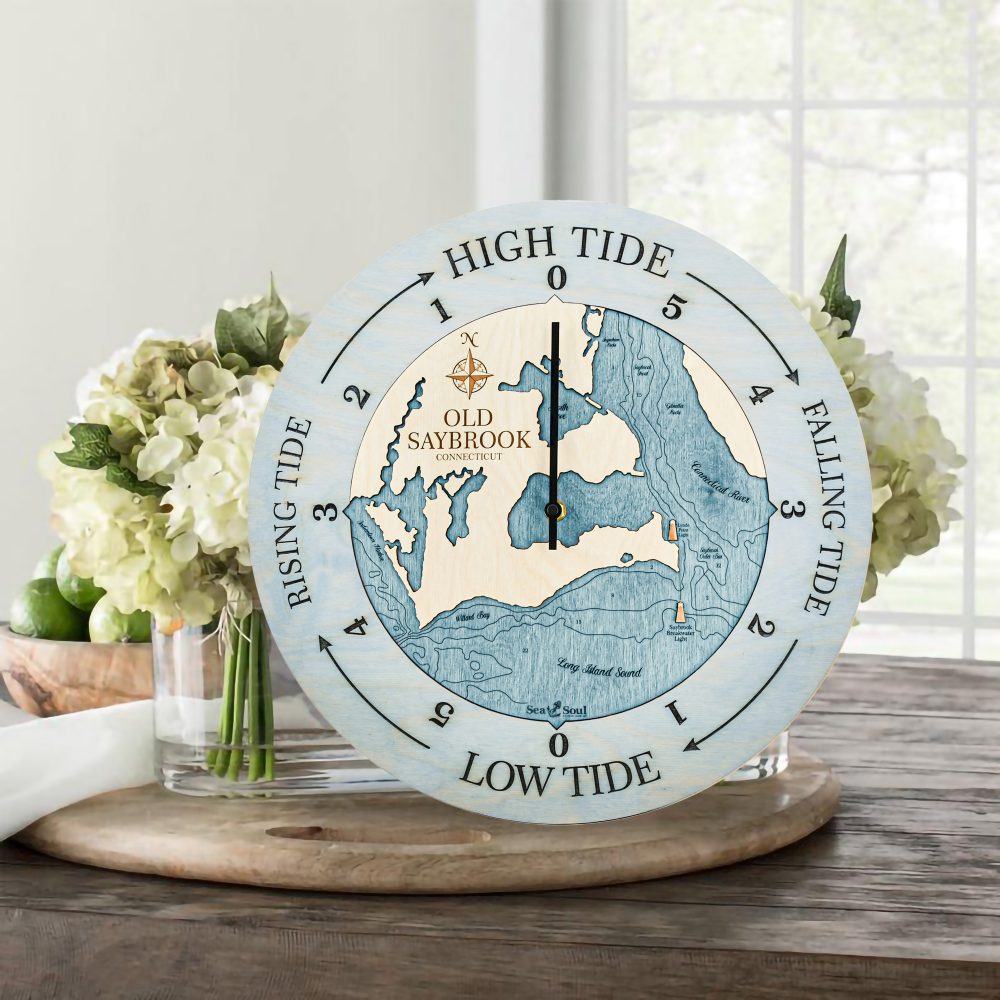 Old Saybrook Tide Clock Bleach Blue Accent with Blue Green Water Sitting on Table with Flowers