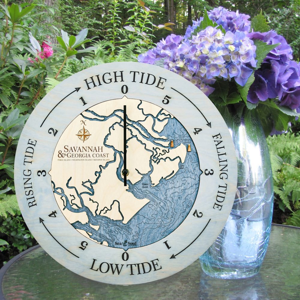 Georgia Coast Tide Clock Bleach Blue Accent with Deep Blue Water Sitting on Outdoor Table with Flowers