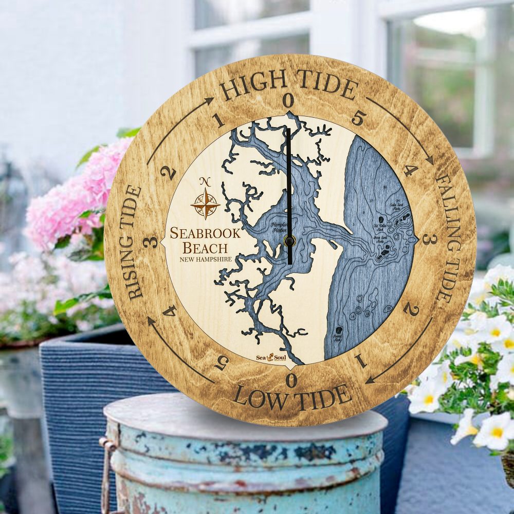 Seabrook Beach Tide Clock Honey Accent with Deep Blue Water Sitting on Bucket Outdoors by Flowers
