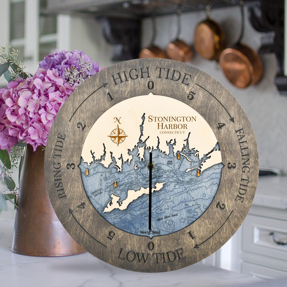 Stonington Harbor Tide Clock Driftwood Accent with Deep Blue Water Sitting on Countertop with Flowers