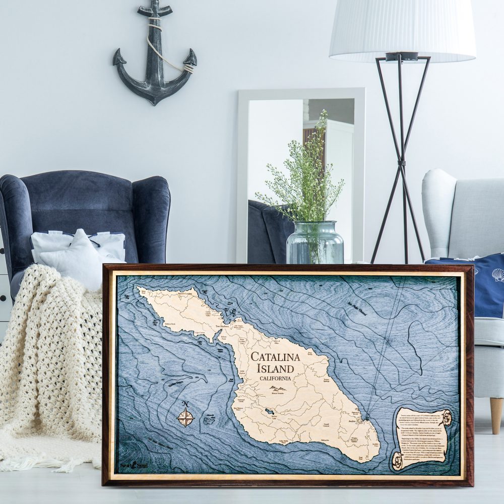 Catalina Island Nautical Map Wall Art Walnut Accent with Deep Blue Water Sitting on Ground of Living Room by Coffee Table