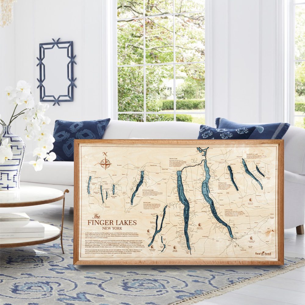 Finger Lakes Nautical Map Wall Art Cherry Accent with Blue Green Water Sitting in Living Room by Coffee Table