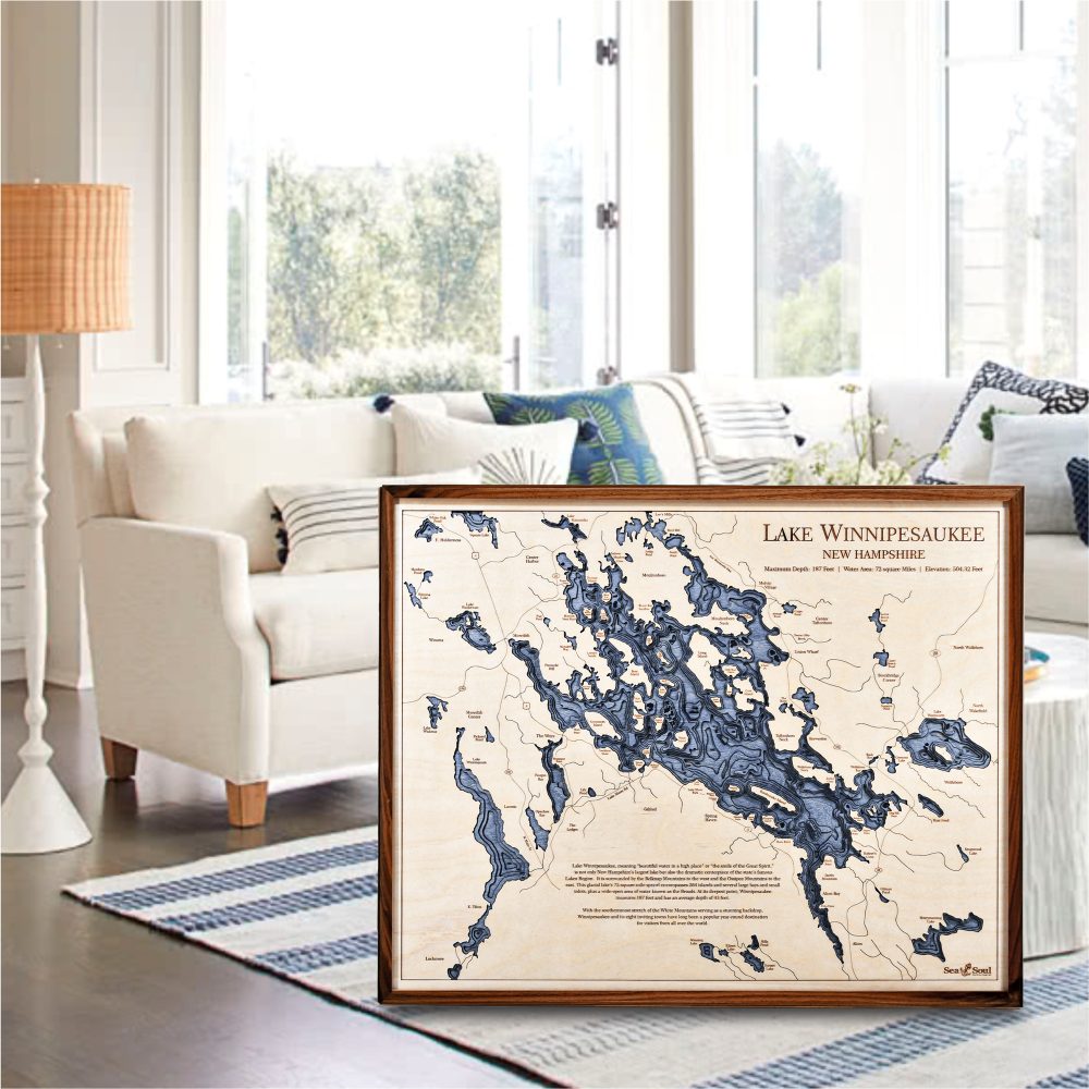 Lake Winnipesaukee Nautical Map Wall Art Walnut Accent with Deep Blue Water Sitting on Living Room Floor by Couch