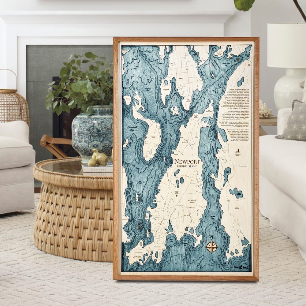 Newport Nautical Map Wall Art Cherry Accent with Blue Green Water Sitting on Living Room Floor by Coffee Table