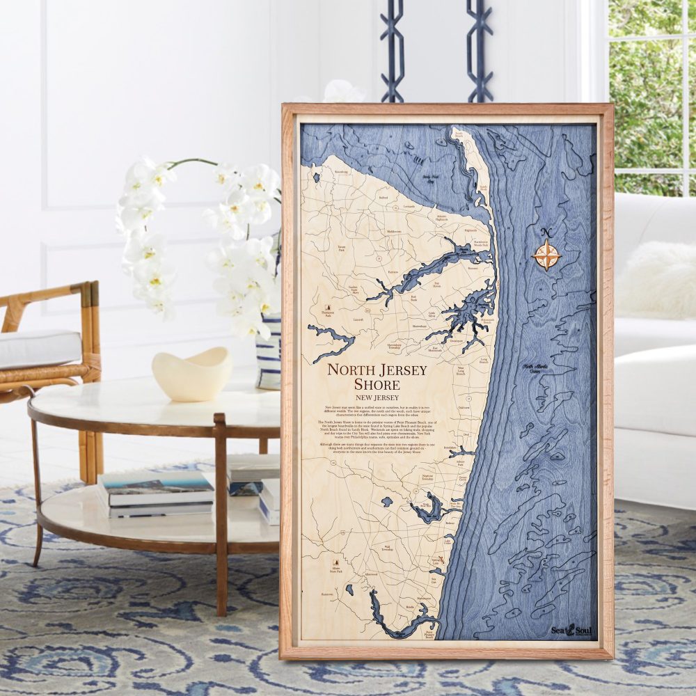 North Jersey Nautical Map Wall Art Oak Accent with Deep Blue Water Sitting on Living Room Floor by Coffee Table