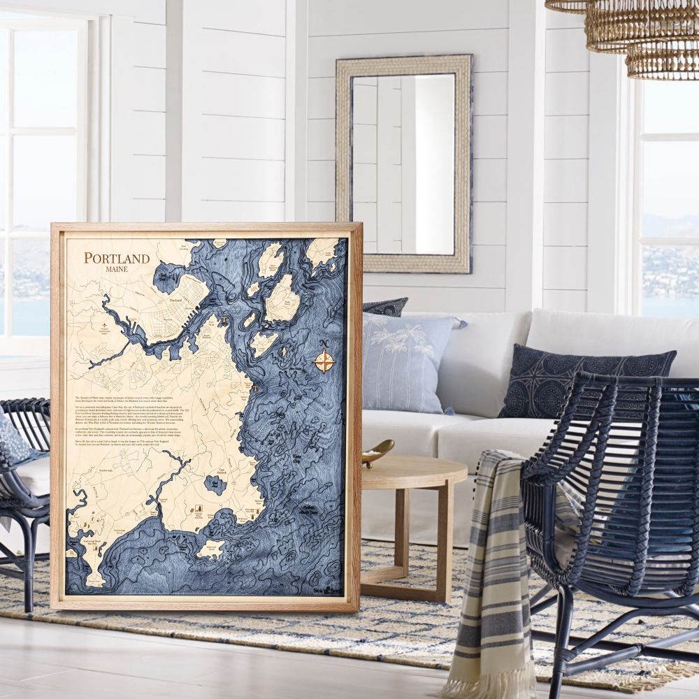 Portland Nautical Map Wall Art Oak Accent with Deep Blue Water Sitting in Living Room by Chair and Coffee Table