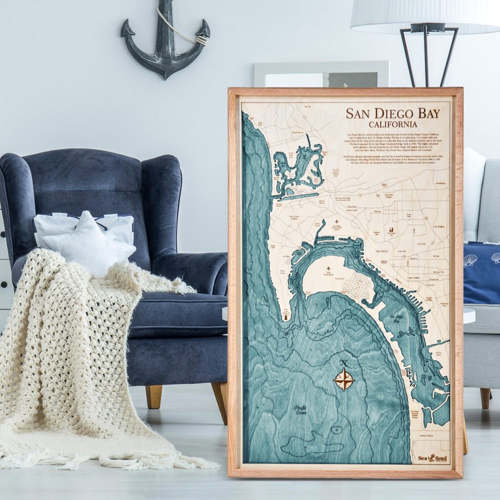 San Diego Nautical Map Wall Art Oak Accent with Blue Green Water Sitting on Ground in the Living Room by Armchair