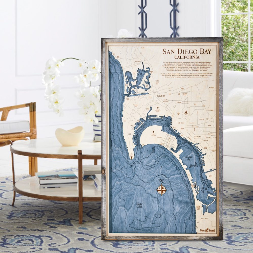 San Diego Nautical Map Wall Art Rustic Pine Accent with Deep Blue Water Sitting on Living Room Floor by Coffee Table