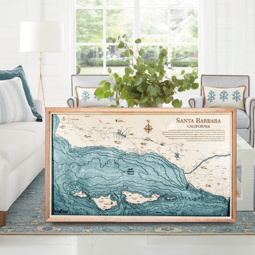 Santa Barbara Nautical Map Wall Art Oak Accent with Blue Green Water Sitting on Living Room Floor by Coffee Table