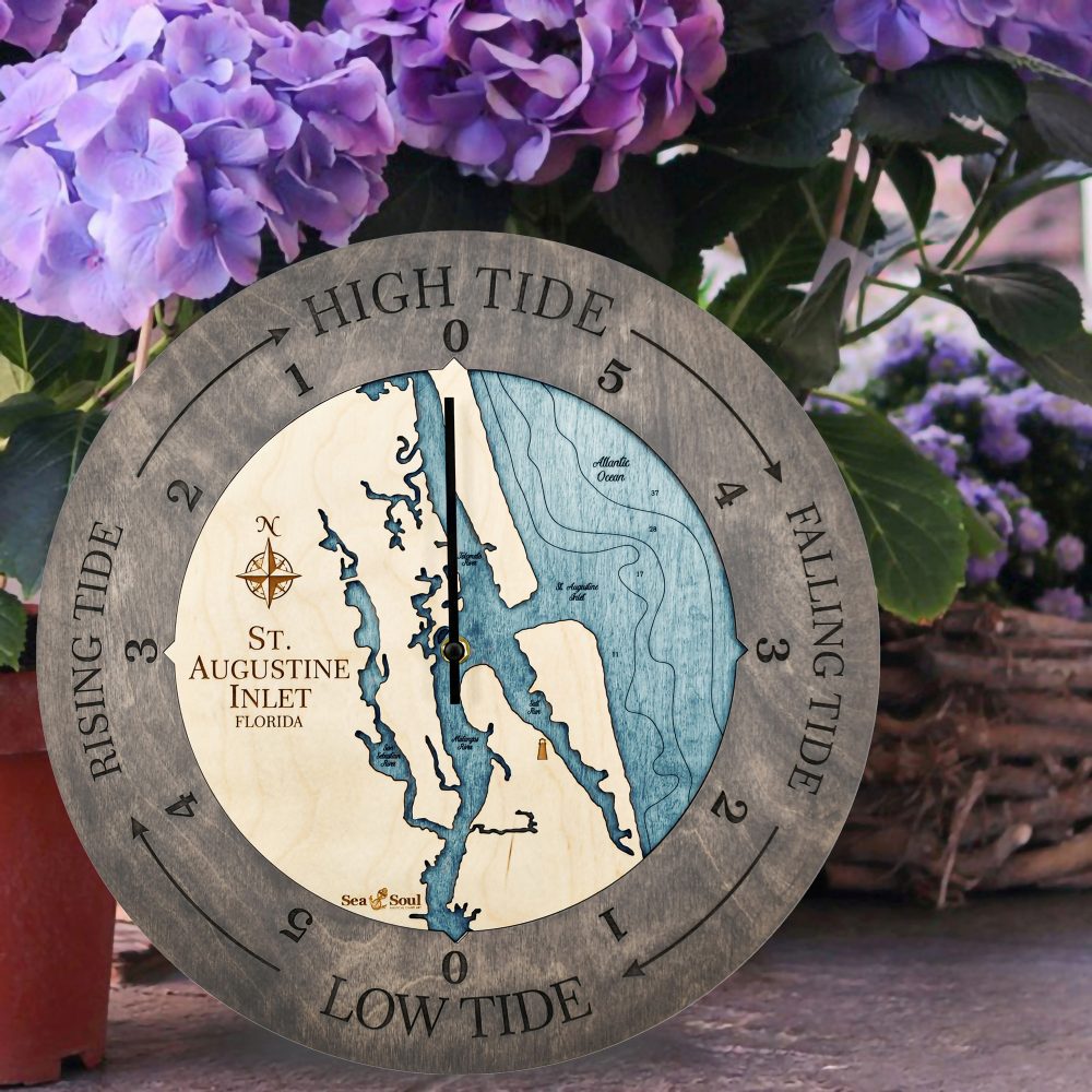 St. Augustine Tide Clock Driftwood Accent with Blue Green Water Sitting on Ground by Flower Pot