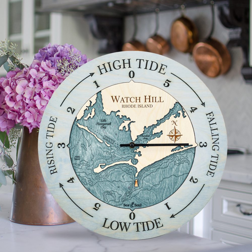 Watch Hill Tide Clock Bleach Blue Accent with Blue Green Water Sitting on Countertop with Flowers