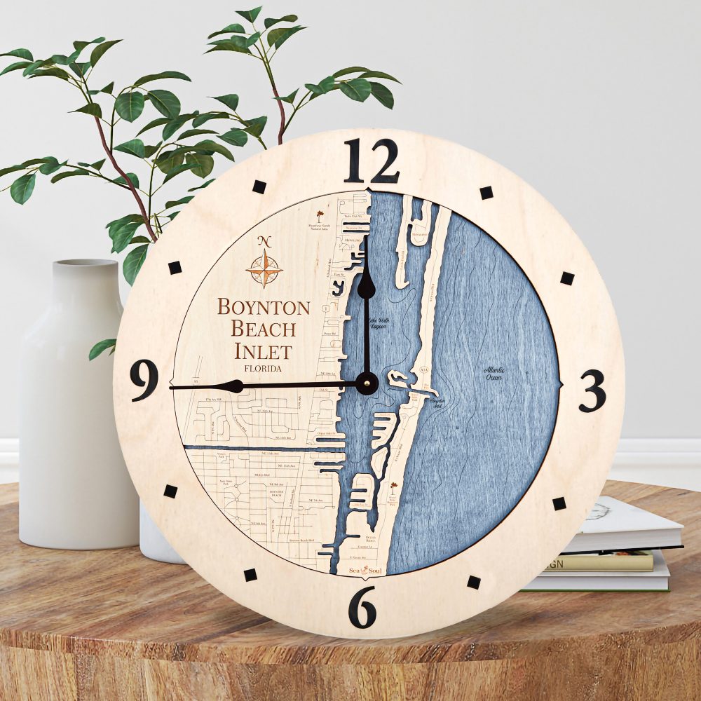 Boynton Beach Nautical Wall Clock Birch Accent with Deep Blue Water Sitting on Coffee Table by Books and Vases