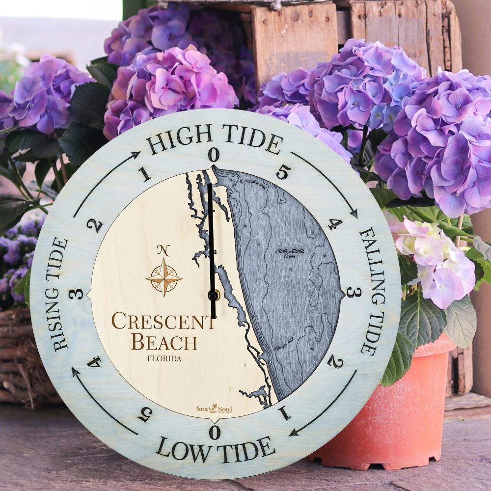 Crescent Beach Tide Clock Bleach Blue Accent with Deep Blue Water Sitting Outside by Flower Pots
