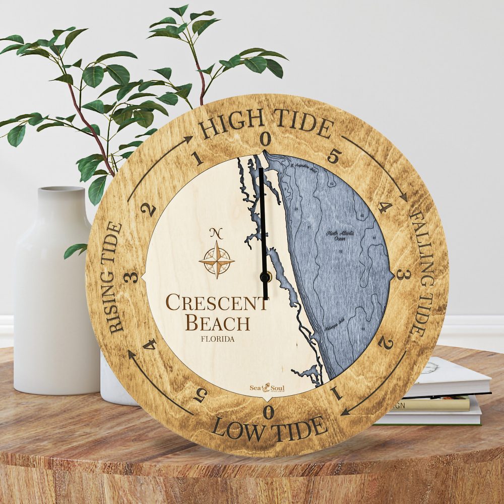 Crescent Beach Tide Clock Honey Accent with Deep Blue Water Sitting on Coffee Table by Books and Vases