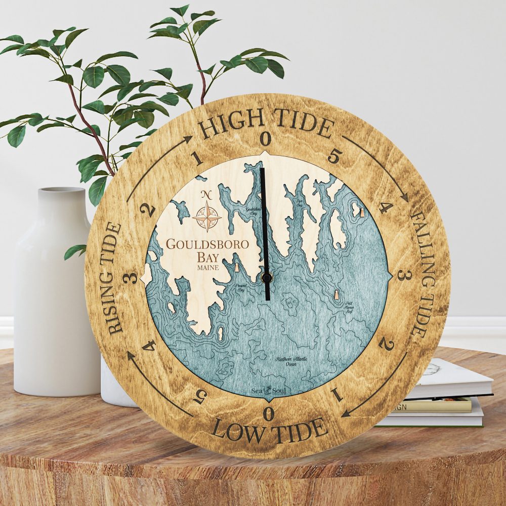 Gouldsboro Bay Tide Clock Honey Accent with Blue Green Water Sitting on Coffee Table by Books and Vases