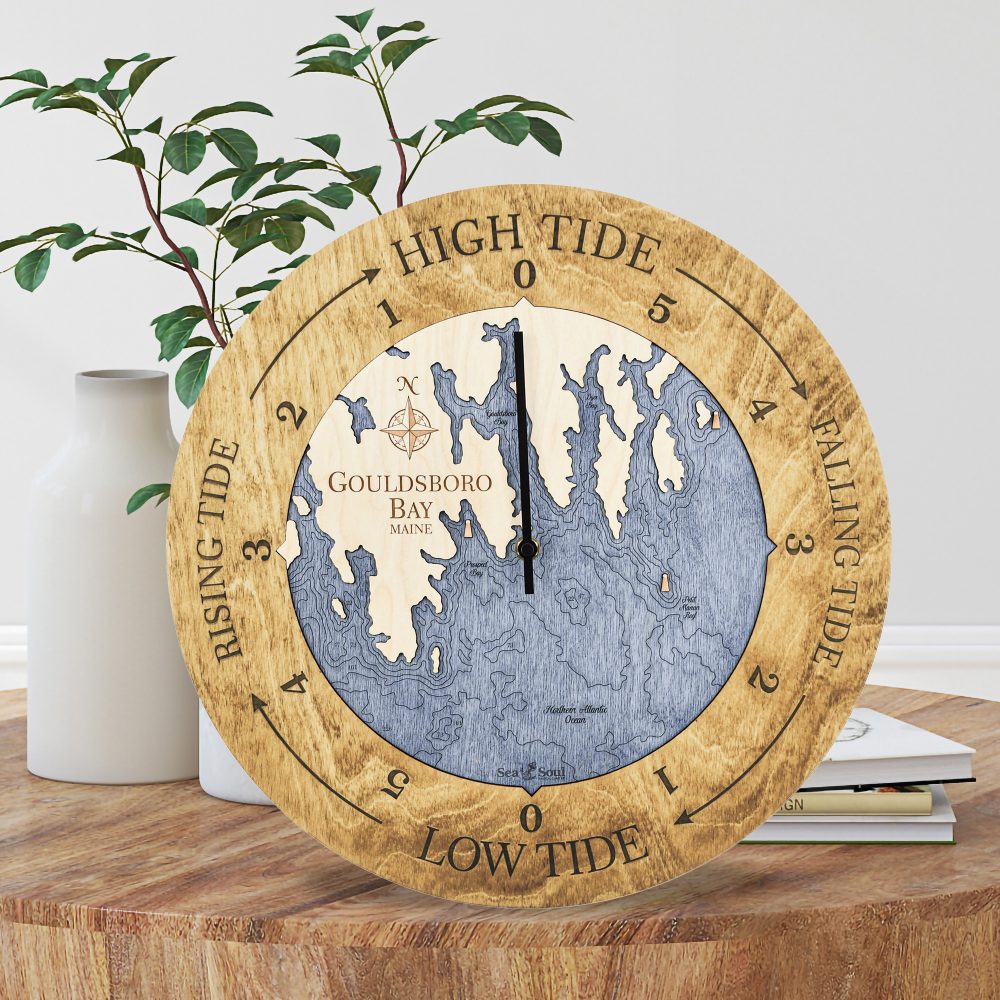 Gouldsboro Bay Tide Clock Honey Accent with Deep Blue Water Sitting on Coffee Table by Books and Vases