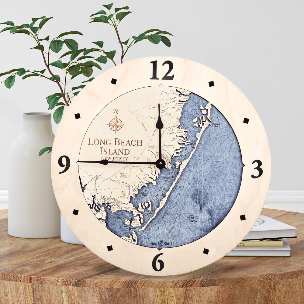 Long Beach Nautical Wall Clock Birch Accent with Deep Blue Water Sitting on Coffee Table by Books and Vases