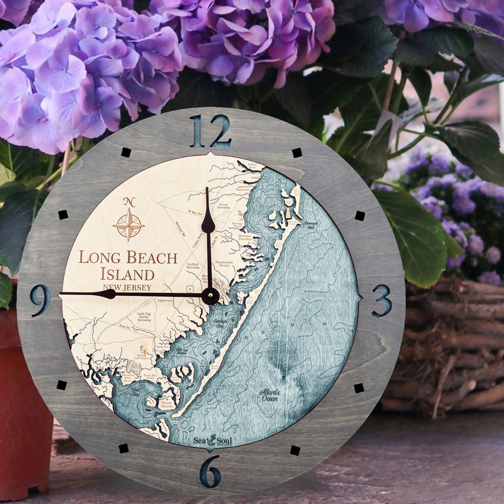 Long Beach Island Nautical Wall Clock Driftwood Accent with Blue Green Water Sitting on Ground by Flower Pot
